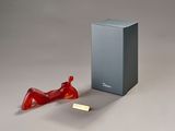 a red object sitting next to a box on a table