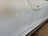a white car with a sticker on the side of it