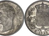 a silver coin with a crown on the front and a crown on the back