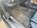 a picture of the inside of a car with the door open