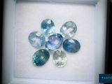 an image of a picture of a flower made of blue and green gems
