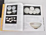 an open book with pictures of bowls and plates on it
