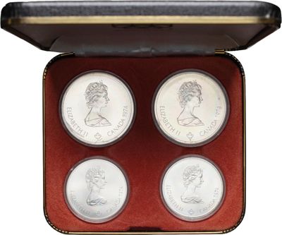 a box with four silver coins in it on a white background