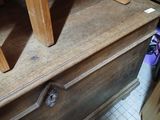 a wooden dresser with a pair of purple shoes on top of it