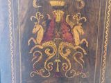 a wooden cabinet that has a painting on it