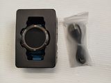 a black box with a watch inside of it on a white surface