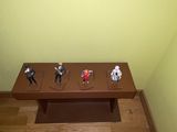 a wooden table with toy figurines on top of it
