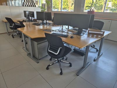 many computers on the desks in this office