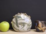 three vases and an apple on a table