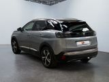 the rear end of a silver car in a large room