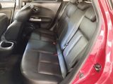 a red car with black leather seats in the back of it