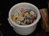 a white bucket filled with assorted items on a table