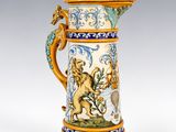 a close up of a blue and white vase with a lion on it