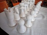 a lot of white vases on a table