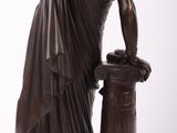 bronze statue of a woman with a bucket of water on a pedestal