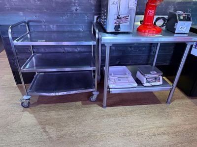 a small table with a microwave on top of it