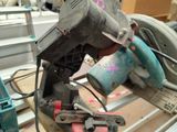 someone is using a circular saw to cut a piece of wood