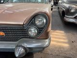 many old cars that are parked in a parking lot