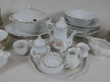 a lot of white dishes and cups on the table