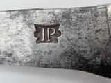 a close up of a knife on a white surface