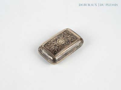 an antique silver cigarette case on a white surface