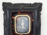 an old picture of a woman in a tortoise shell frame