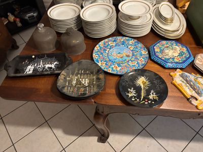 many plates and bowls on a table in a room