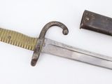 an old knife with a wooden handle sitting on top of a white surface