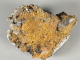 a close up of a piece of rock with a yellow substance on it