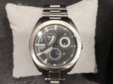 a watch that is sitting on top of a pillow