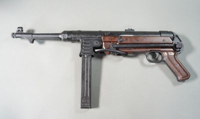rifle on a table with a magazine and magazine on it