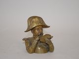brass figurine of a man in a hat and holding a bird