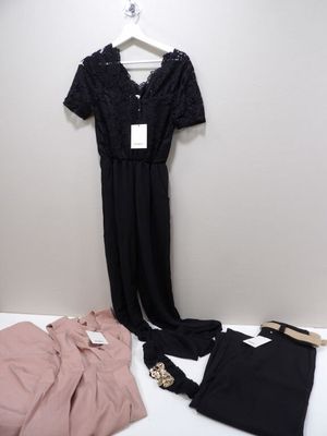 black lace jumpsuits, pink shirt and black pants on a hanger