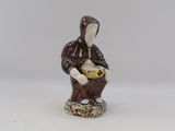 a figurine of a woman holding a basket of food