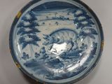 a blue and white plate with a bull on it