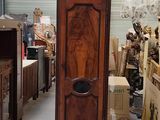 a tall wooden grandfather clock in the middle of a room