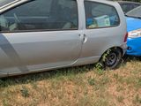 two small cars parked next to each other in the grass