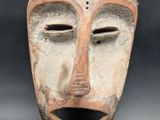 an image of a wooden mask on a black background