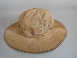 a brown hat with eyes on it on a white surface