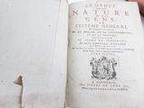 a person holding an old book in their hand