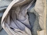 a close up of a bag of clothes on a bed