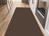 the brown area rug is on the wooden floor in the kitchen