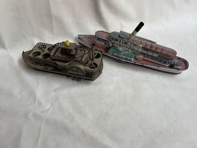 deux petits bateaux en plastique posés sur une surface blanche