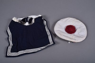 a white hat and a blue shirt on a table