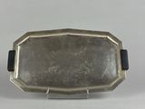 a silver plate with a black ribbon around it