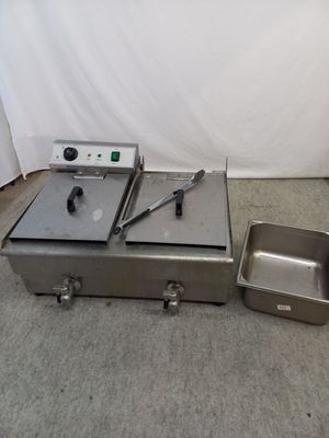 a silver box and a metal pan on the floor