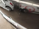 a silver car with graffiti on it parked in a parking lot