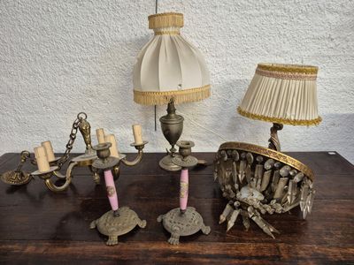 a table with a lamp, a lamp shade, and other items on it