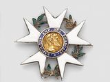 a gold medal with a blue and white design on it