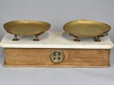 pair of antique brass scale on marble base with clock on top